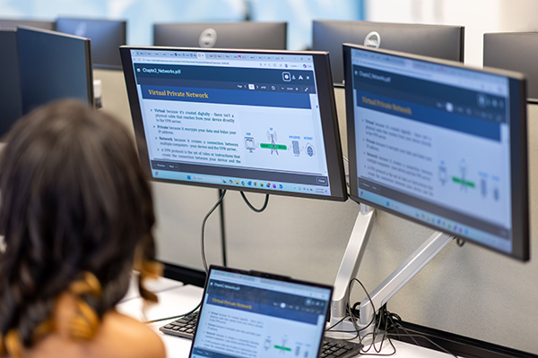 A student at a workstation learning about computer networks