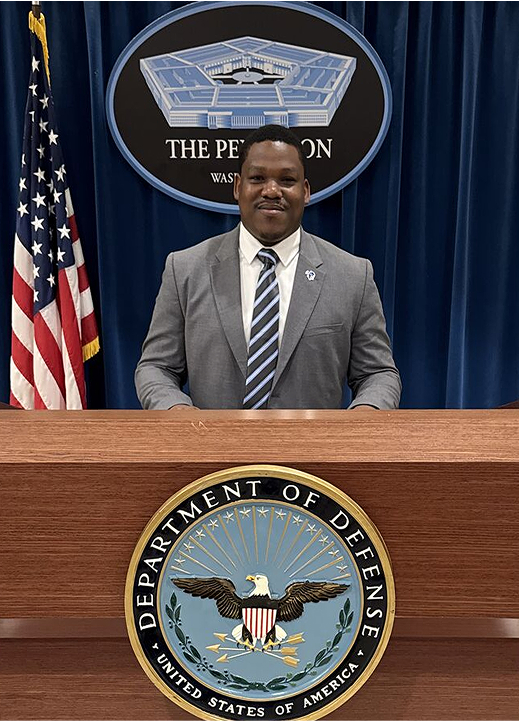 Emmanuel Ogundele at a podium in the Pentagon