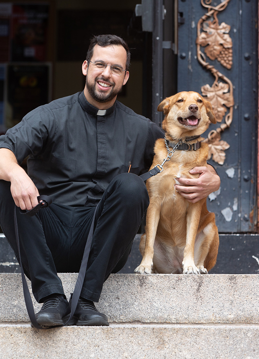 Father Joe Furnaguera with a dog