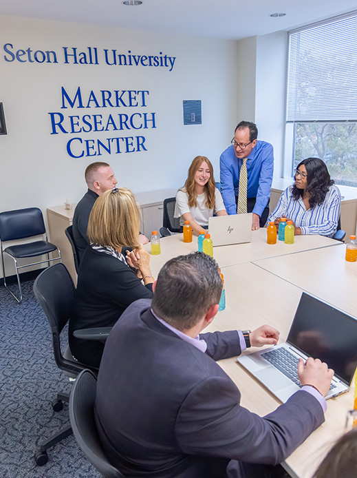 Students doing research with business partners at the Market Research Center.