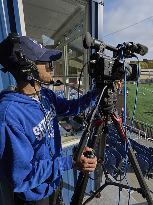 Student recording a Pirates baseball game.