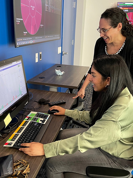 A Stillman faculty member working with a student on a computer.